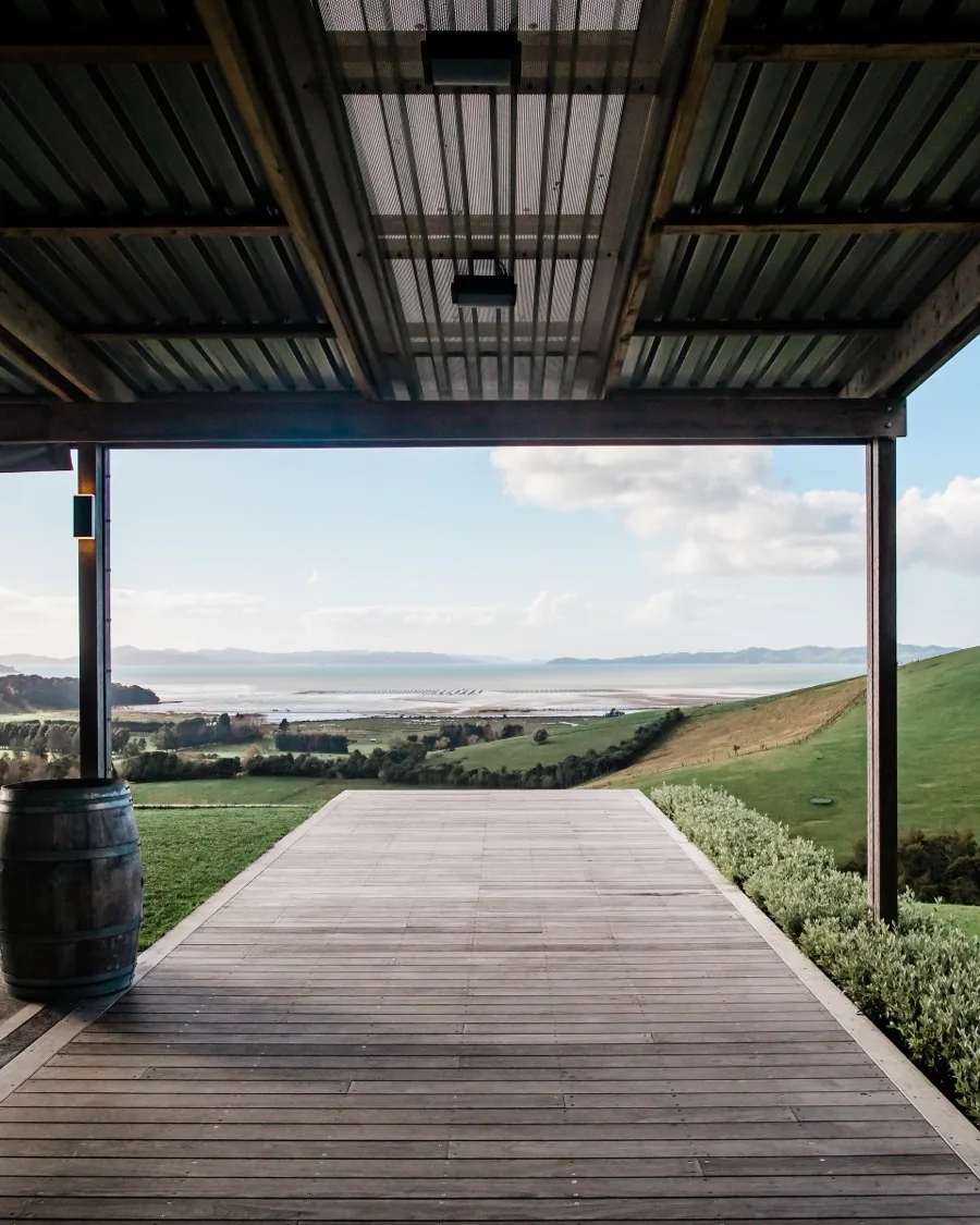 View from the Kauri Bay deck across rolling hills to the Hauraki Gulf